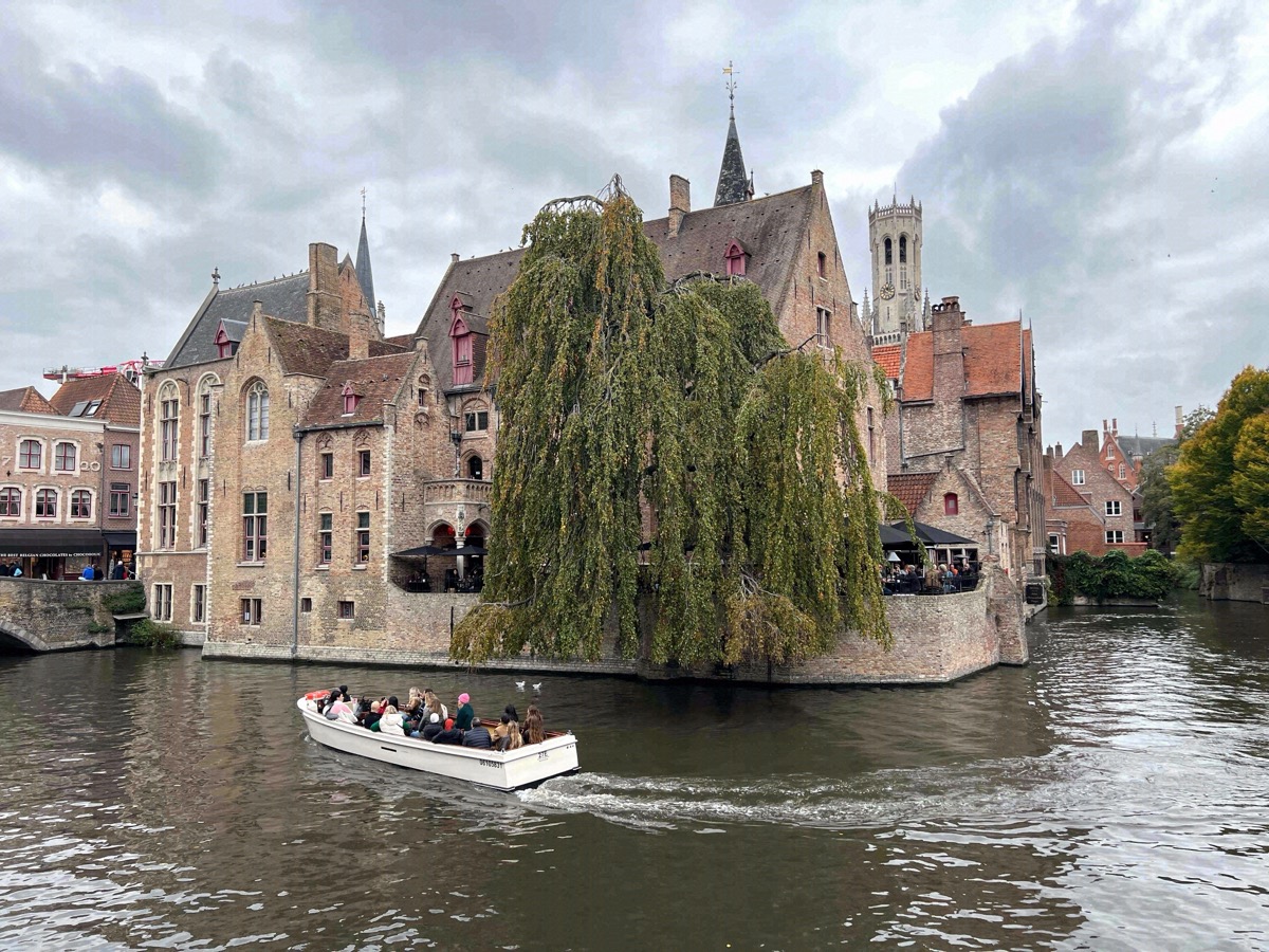 Canal at the Rozenhoedkaai with a tour boat and the Belfry behind